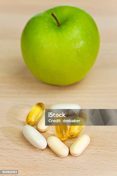 Green Apple And Nutrition Supplement Tablets Or Medicine Stock Photo - Download Image Now