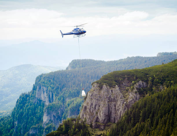 istock helicopter carrying goods on mountain 969862666