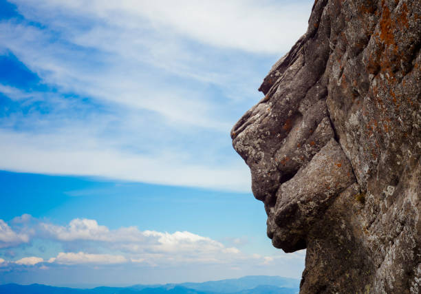 sphynx face in nature with rock and sky