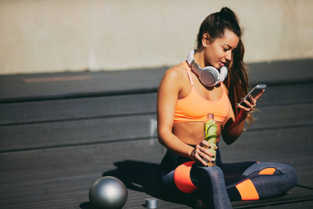 istock Woman sitting and taking a rest from exercising. 969865598