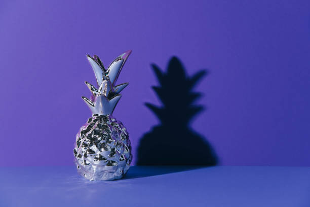 istock Tropical golden Pineapple on ultraviolet background 969869576
