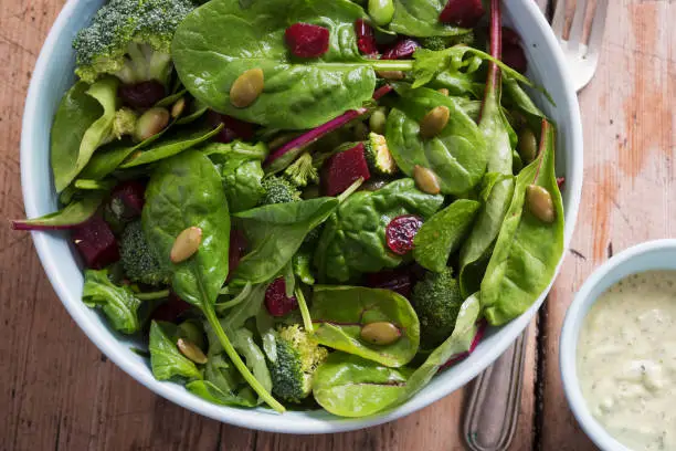 Superfood salad bowl. Mixed leaf salad with beetroot & pumpkin with creamy avocado dressing.