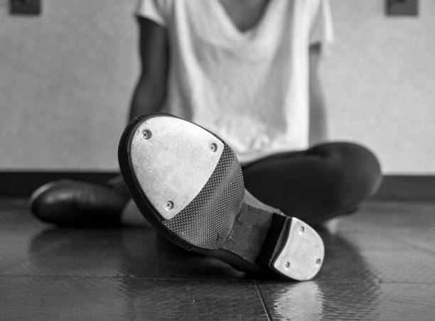 istock Black and white version of Tap dancer relaxing in class 969884318