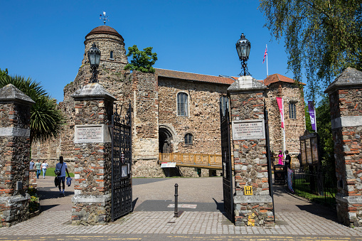 COLCHESTER, UK - MAY 7TH 2018: A view of Colchester Castle through one of the entrances into Colchester Castle Park, in the hostoric market town of Colchester in Essex, UK, on 7th May 2018.