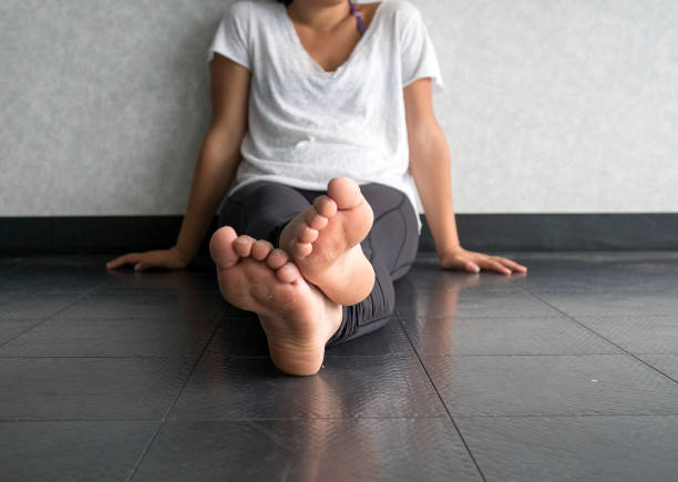istock Young woman doing yoga taking a break sitting cross legged 969887596
