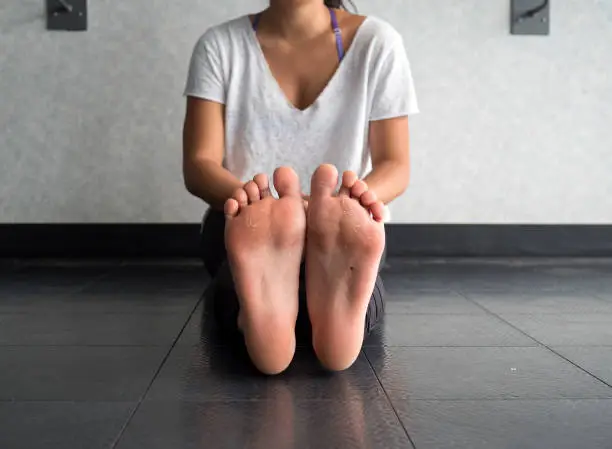 Bottom view of the callused feet of a dancer in a dance studio