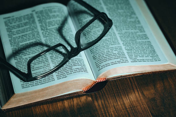 istock Open Bible with glasses on top 969893062