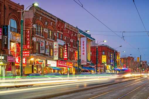 Long exposure stock photograph of Spadina Avenue in Chinatown, downtown Toronto, Ontario, Canada at twilight blue hour.