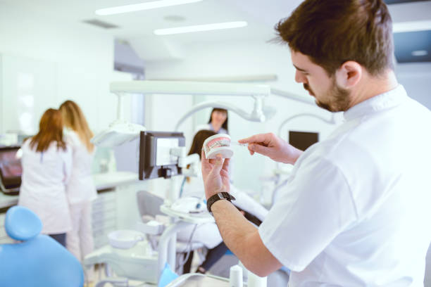 istock Dental Technician Cleaning Prosthetic Teeth With Toothbrush 969906874