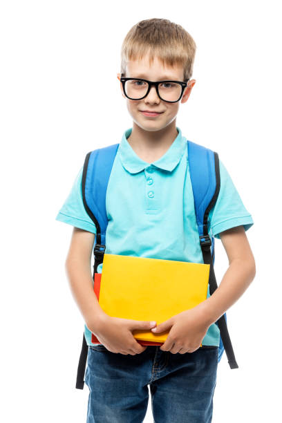 istock boy in glasses with books posing on white background 969909618
