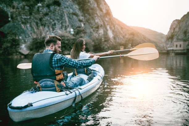 istock Young Couple Kayaking On Lake During Sunset 969909874