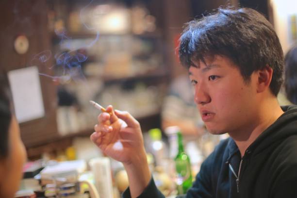 istock YOung man smoking at bar 969909958