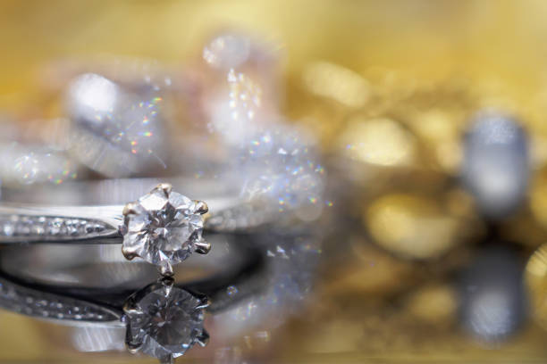 istock Luxury gold Jewelry diamond rings with reflection on black background 969910072
