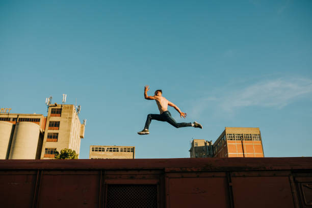 istock Athlete running and jumping on the abandoned train wagon 969923860