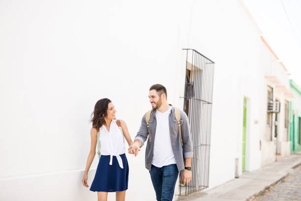 istock Cute couple walking and looking each other 969937958