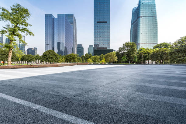istock modern business office buildings with empty road,empty concrete square floor 969940480