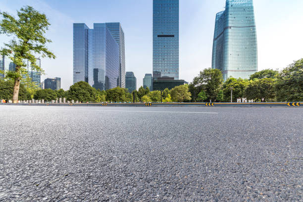 istock modern business office buildings with empty road,empty concrete square floor 969940628