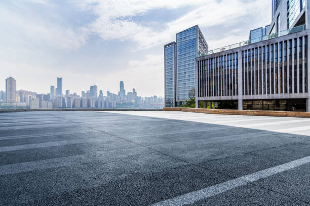 istock modern business office buildings with empty road,empty concrete square floor 969943232