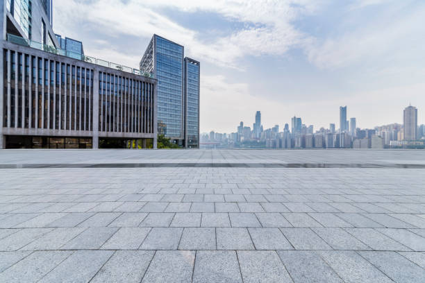 istock modern business office buildings with empty road,empty concrete square floor 969943274
