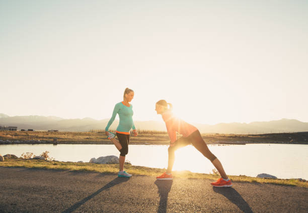 istock Two Female Runners Warming Up on a Trail at Sunset 969945924