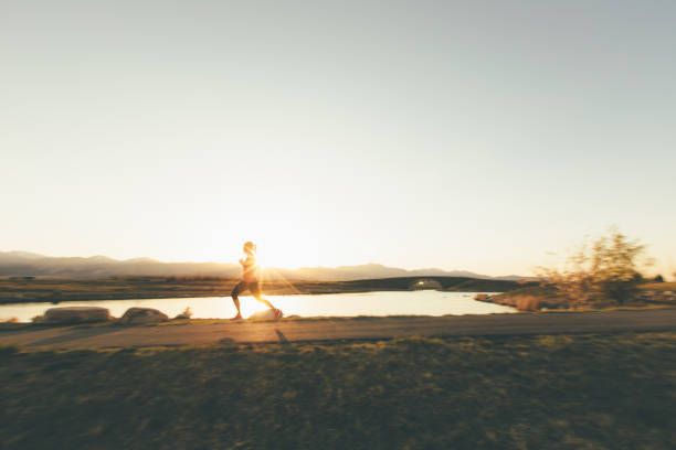 istock Female Runner on a Trail at Sunset 969945950