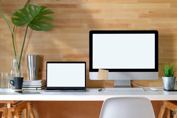 istock Mockup blank screen desktop and laptop computer on desk. 969952558