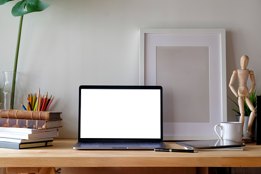 Workspace with mockup la[top and poster.
