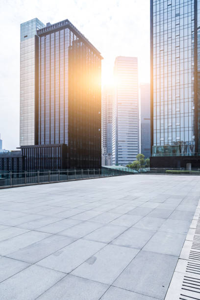 istock modern business office buildings with empty road,empty concrete square floor 969955204