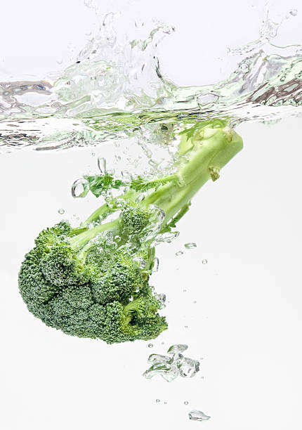 istock Green broccoli falling in water with air bubbles 96995574