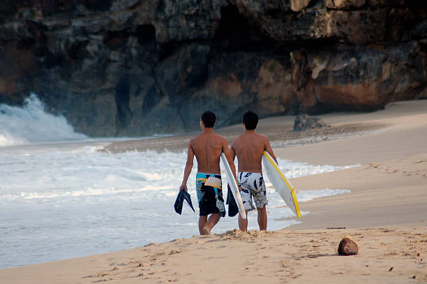 Surfers on Beach stock photo
