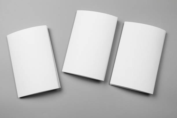 istock Blank portrait mock-up paper. brochure magazine isolated on gray, changeable background / white paper isolated on gray 969969708