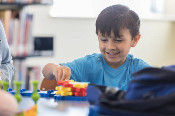 istock Adorable boy playing with toy gears 969970464
