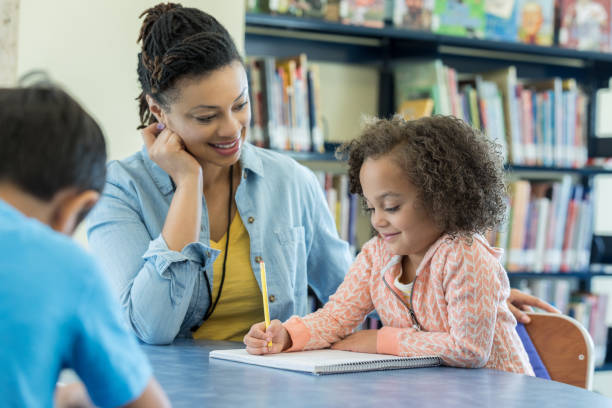 istock Preschool teacher works with students 969970484