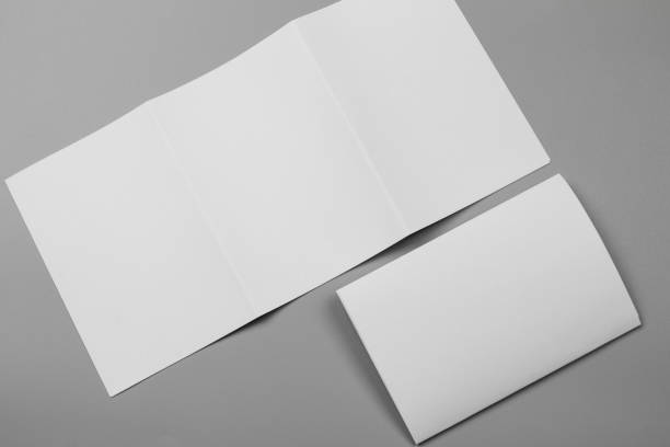 istock Blank portrait mock-up paper. brochure magazine isolated on gray, changeable background / white paper isolated on gray 969976042