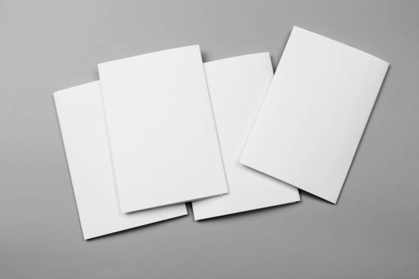 istock Blank portrait mock-up paper. brochure magazine isolated on gray, changeable background / white paper isolated on gray 969976090