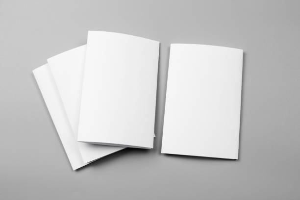 istock Blank portrait mock-up paper. brochure magazine isolated on gray, changeable background / white paper isolated on gray 969976140
