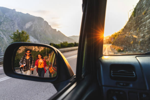 istock Backpackers hitchhiking on the road 969978690