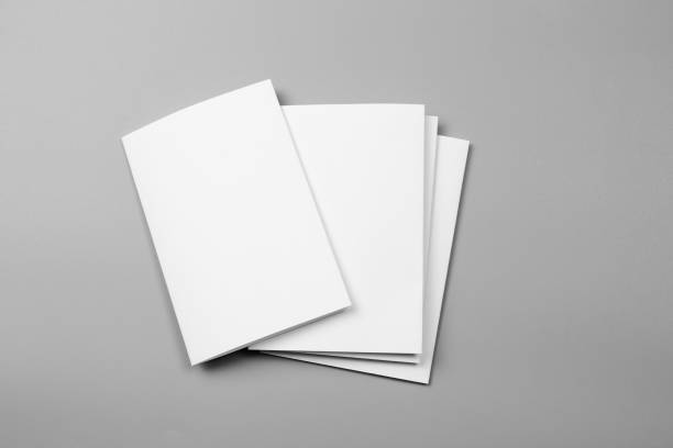 istock Blank portrait mock-up paper. brochure magazine isolated on gray, changeable background / white paper isolated on gray 969979292