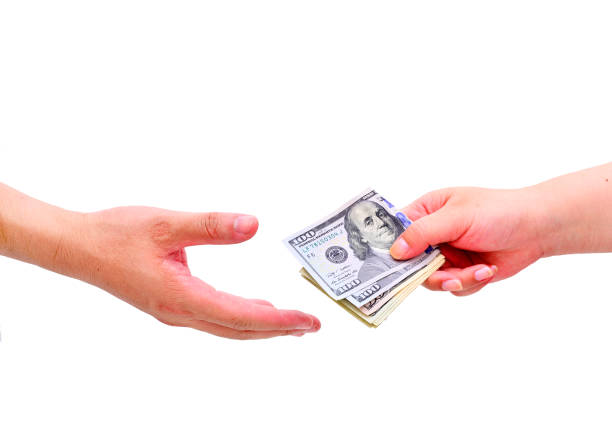 Closeup hands giving money isolated on white background. A financial transaction between two parties.