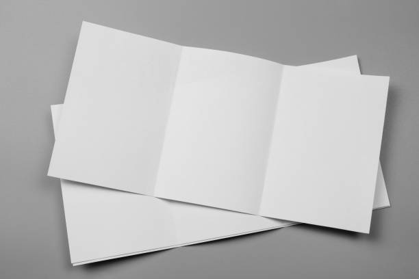 istock Blank portrait mock-up paper. brochure magazine isolated on gray, changeable background / white paper isolated on gray 969982184
