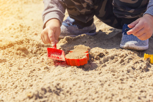 istock baby's hands in the sand, baby playing in the sand 969984868