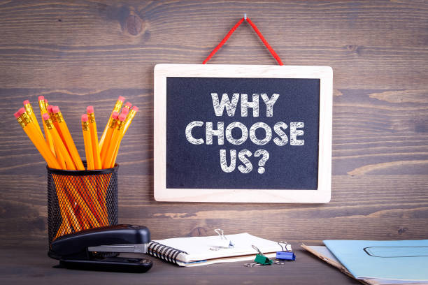 istock Why choose us? Chalkboard on a wooden background. 969985354