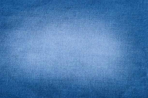 istock Natural wallpaper of blue jeans texture background 969987592
