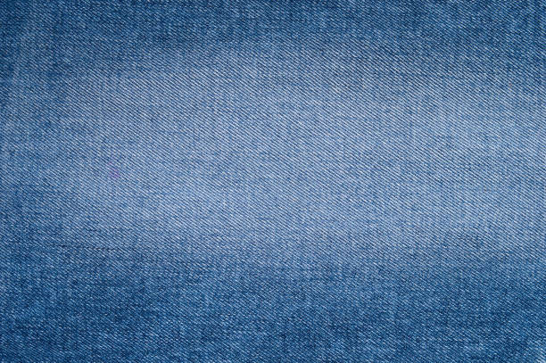 istock Natural wallpaper of blue jeans texture background 969987614