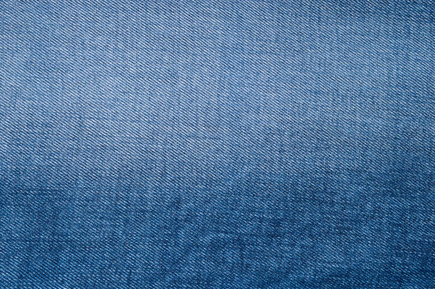 istock Natural wallpaper of blue jeans texture background 969987616