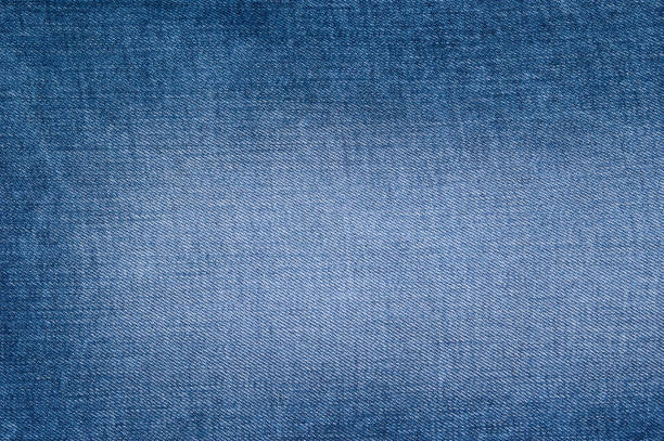 istock Natural wallpaper of blue jeans texture background 969987620