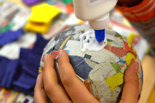 Children hands are making a pinata.