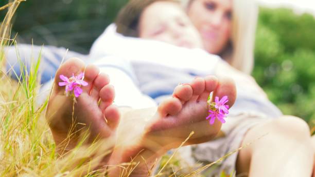 istock Mother and child lying in grass 969988504