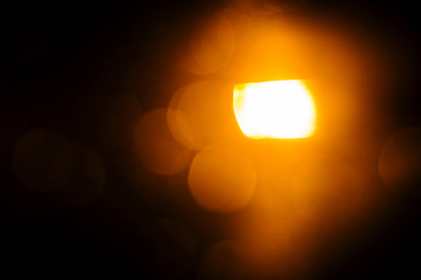 istock orange shinny blurred spotlight on a black background 969994400