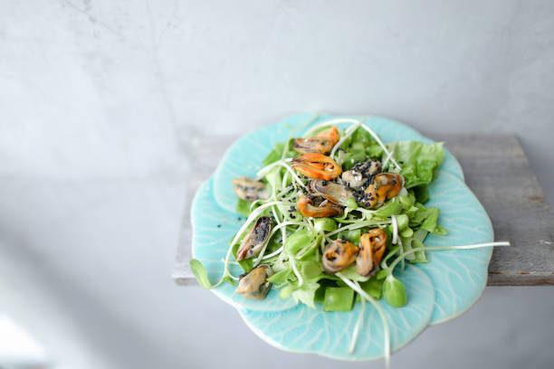 istock Thai green salad with shrimps on white plate 969994642